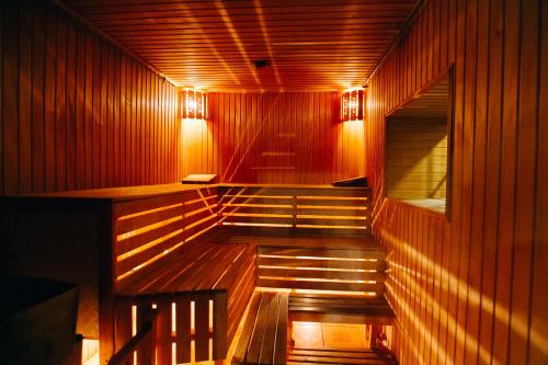 a sauna with stairs and lights on the wall at Bukovyna Hotel in Chernivtsi