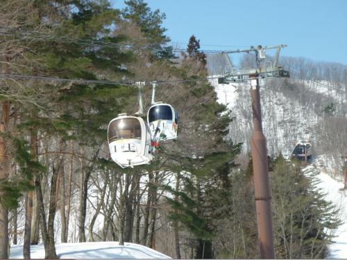 two trolley cars on a ski lift in the snow at Stayful House Nakamachi in Hakuba
