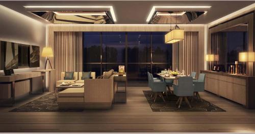 a dining room and living room with a table and chairs at Royal M Hotel Abu Dhabi by Gewan in Abu Dhabi