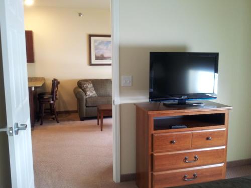 a living room with a flat screen tv on a dresser at Extended Stay Americas Suites - Minot in Minot