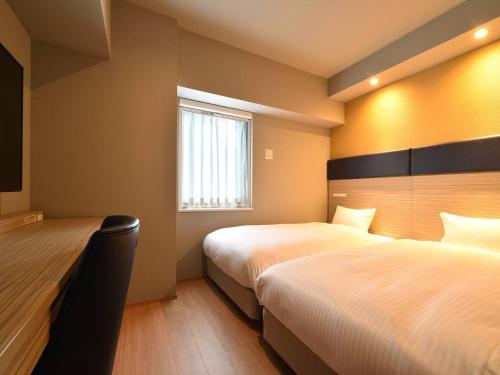 Postel nebo postele na pokoji v ubytování Hotel WBF Grande Hakata