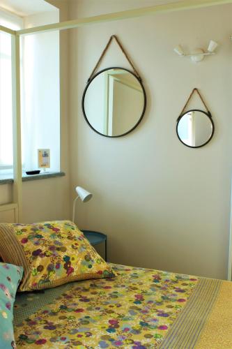 a bedroom with a bed and a mirror on the wall at La Basiglia B&B in Monforte dʼAlba