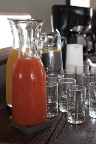 a jug and glasses of juice on a table at Paternoster Dunes Boutique Guesthouse in Paternoster