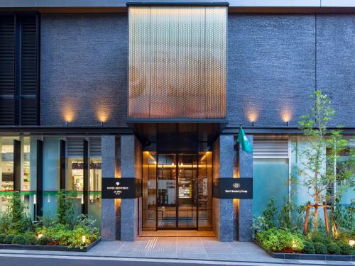 a facade of a building with a glass door at Hotel Monterey Le Frere Osaka in Osaka