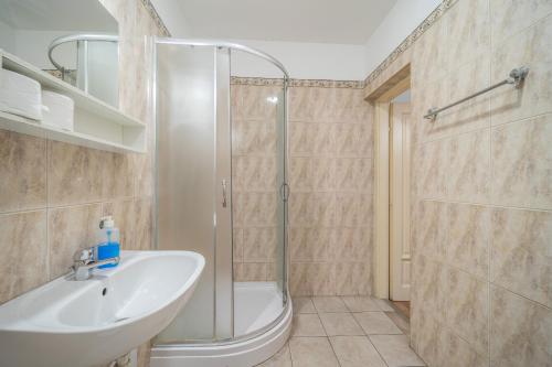 a bathroom with a shower and a sink at Silver Hotel Budapest City Center in Budapest