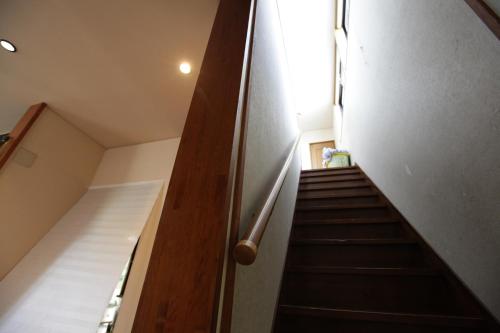 a stairway leading up to a building with a stair case at Kasumi-an in Kumamoto