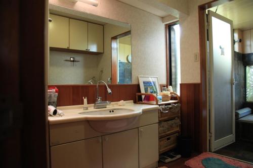a bathroom with a sink and a mirror at Kasumi-an in Kumamoto