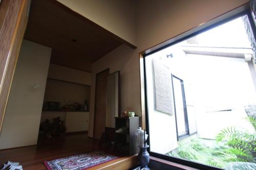 a living room with a large window in a room at Kasumi-an in Kumamoto