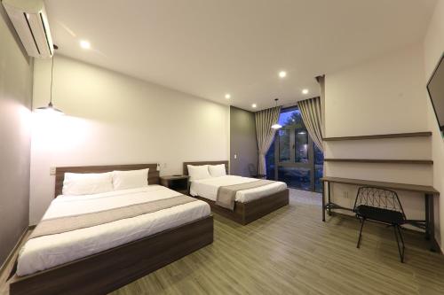 a hotel room with two beds and a piano at Hill Bungalow in Hue