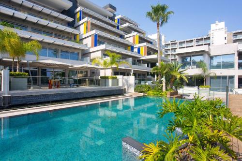 an image of a swimming pool in front of a building at Opera Exclusive Apts by TrulyCyprus in Limassol