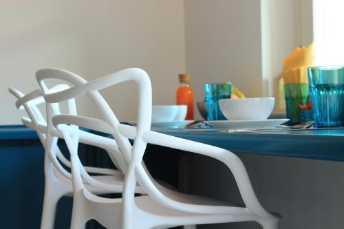 a white chair sitting in front of a table at La Basiglia B&B in Monforte dʼAlba