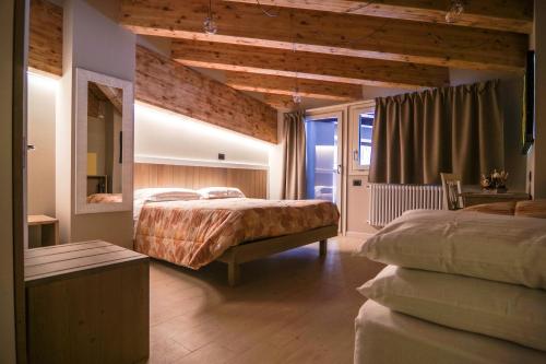 Posteľ alebo postele v izbe v ubytovaní Hotel Laghetto