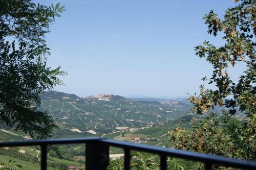 a view of a valley from a balcony with trees at La Basiglia B&B in Monforte dʼAlba