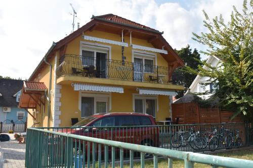 a house with a car parked in front of it at Villa Bella Apartman in Bük