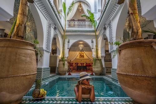 a large room with a large tub and a large mirror at Riad Jemaa El Fna & Spa in Marrakesh