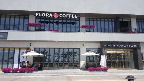 a store with umbrellas in front of a building at Hotel Wooyeon Flora in Boryeong