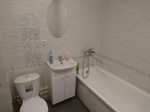 a bathroom with a sink and a toilet and a bath tub at Studio Loft in Saransk
