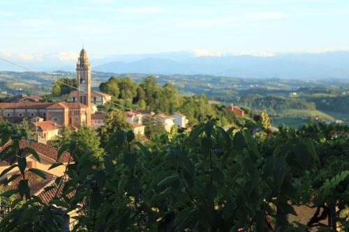 a view of a town from a hill with a clock tower at La Basiglia B&B in Monforte dʼAlba