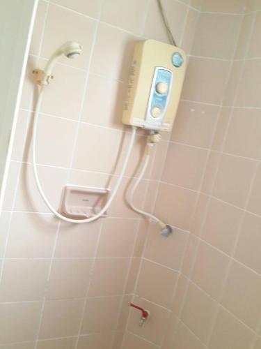 a shower in a bathroom with a shower head at Sathitsit Mansion in Bangkok