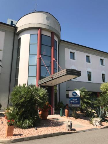 a building with a spiral staircase in front of it at Best Western Hotel Solaf in Medolago
