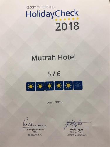 a poster for the holiday check of the munich hotel at Mutrah Hotel in Muscat