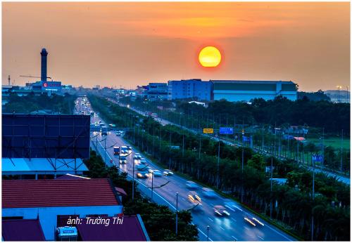 a view of a busy city street at sunset at Anova Airport Hotel - Convenient & Friendly in Noi Bai