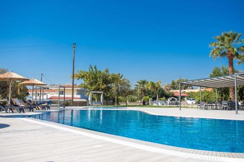 a swimming pool with blue water in a resort at Madison Boutique, Faliraki in Faliraki
