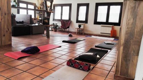 a room with a bunch of yoga mats on the floor at Hostal Rural Sant Climent in Taüll