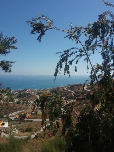 a view of the ocean from the top of a hill at El Peñoncillo in Torrox