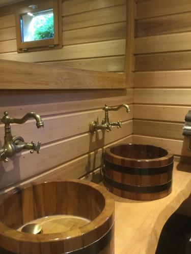 La salle de bains est pourvue d'un lavabo en bois et d'une télévision. dans l'établissement Les Crinieres En Brie, à Saint-Ouen-en-Brie