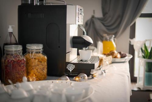 a coffee maker sitting on top of a counter with food at Szafirowy Dwór Hotel & Restauracja in Gliwice
