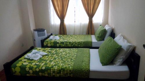 Postel nebo postele na pokoji v ubytování Florabells Iraya Guest House - Batanes