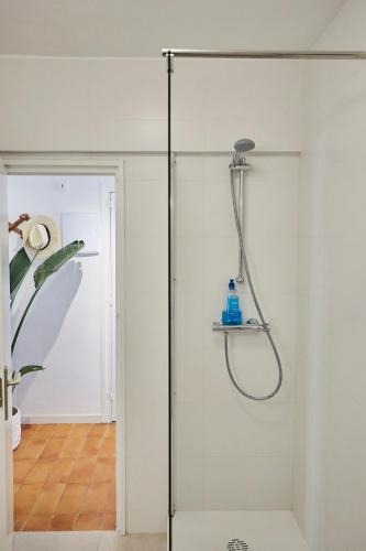 a shower in a bathroom with a glass door at Beachfront Resort Apartment in Castelldefels
