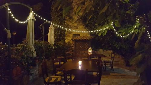 a restaurant with a table and lights at night at Carretiello in Roccadaspide