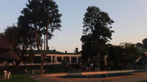 een huis met een zwembad ervoor bij Montclair Hotel and Casino in Nyanga