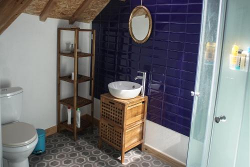 a bathroom with a sink and a toilet at Grand studio duplex proche de la mer in Fécamp
