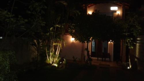 a night time picture of a house with lights at SA Village in Dambulla