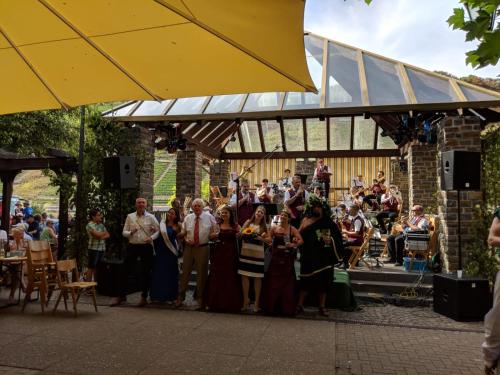 a group of people standing in front of a band at Ferienwohnungen Am Bruttiger Moselsteig in Bruttig-Fankel