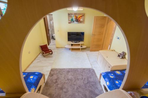 a view of a living room through a round mirror at Villa ADELHEIDE - Spa, BBQ & Jacuzzi in Beli Iskar