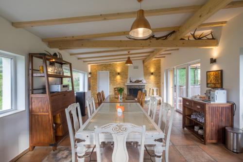 a dining room with a table and chairs at Villa ADELHEIDE - Spa, BBQ & Jacuzzi in Beli Iskar