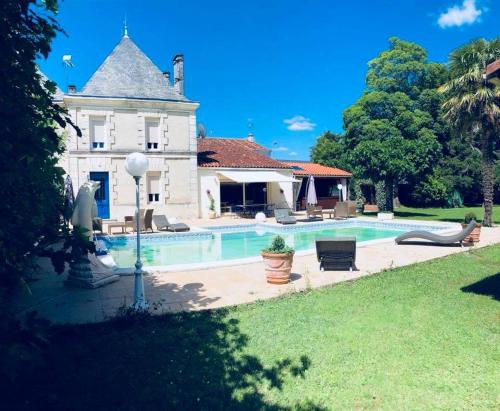 a house with a swimming pool in the yard at les roulottes de dilou Cerise in Matha
