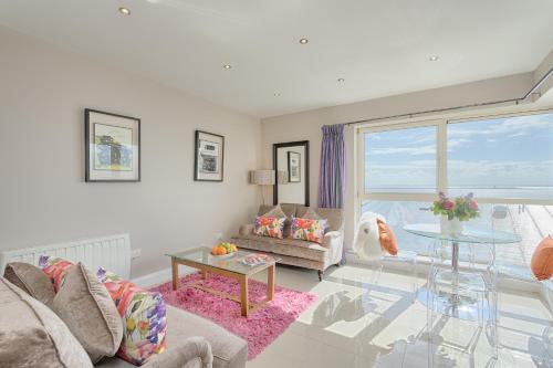 
a living room filled with furniture and a window at Jameson Court Apartments in Galway
