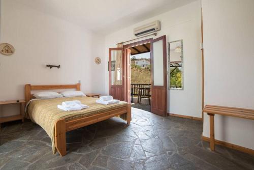 a bedroom with a bed with two towels on it at Nicolas Pension in Skiros