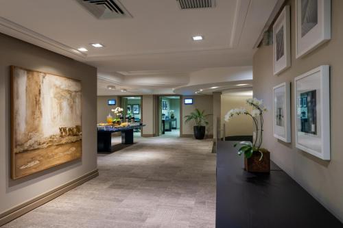 a hallway of a hotel lobby with a painting on the wall at Blue Tree Premium Florianópolis in Florianópolis