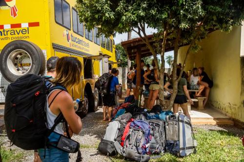 a group of people standing next to a yellow bus at Bonito HI Hostel e Pousada in Bonito