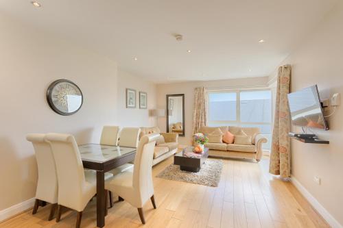 
a living room filled with furniture and a large window at Jameson Court Apartments in Galway

