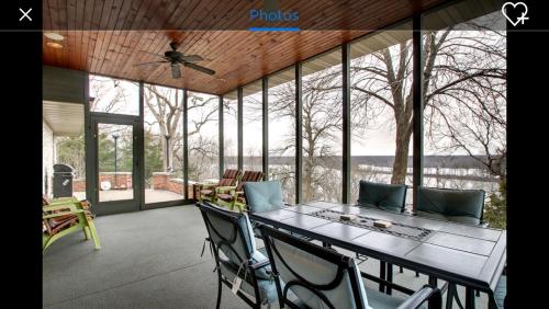 a screened in porch with a table and chairs at Affordable Luxury Mansion in Quincy