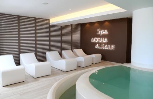 a spa room with white chairs and a sink at Grand Hotel Terme in Margherita di Savoia