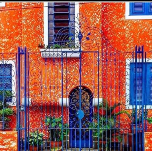 an orange building with a gate in front of it at Mansion Aline in Rio de Janeiro