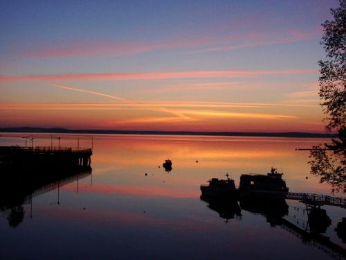 a sunset over a body of water with boats in it at Atlantic Oceanside Hotel & Conference Center in Bar Harbor